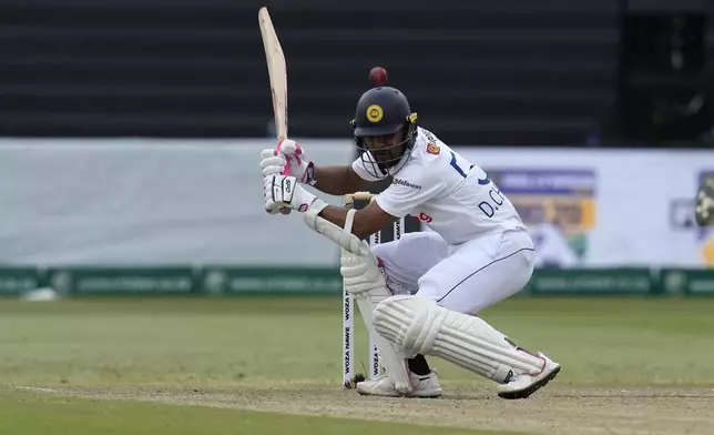 Sri Lanka's Dinesh Chandimal ducks under the ball during the third day of the first Test cricket match between South Africa and Sri Lanka, at Kingsmead stadium in Durban, South Africa, Friday, Nov. 29, 2024. (AP Photo/Themba Hadebe)