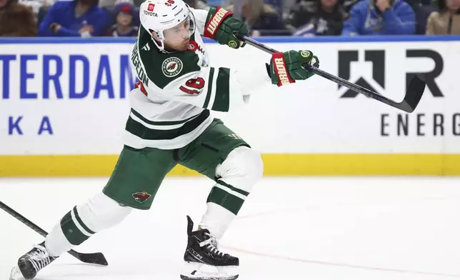 Minnesota Wild defenseman Jared Spurgeon (46) takes a shot on net during the second period of an NHL hockey game against the Buffalo Sabres, Wednesday, Nov. 27, 2024, in Buffalo, N.Y. (AP Photo/Jeffrey T. Barnes)