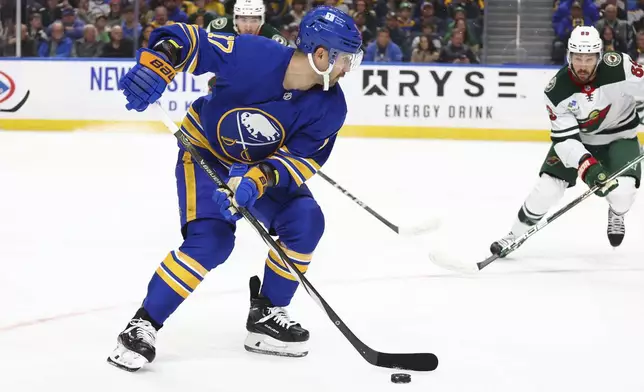 Buffalo Sabres left wing Jason Zucker (17) carries the puck into the zone during the first period of an NHL hockey game against the Minnesota Wild, Wednesday, Nov. 27, 2024, in Buffalo, N.Y. (AP Photo/Jeffrey T. Barnes)