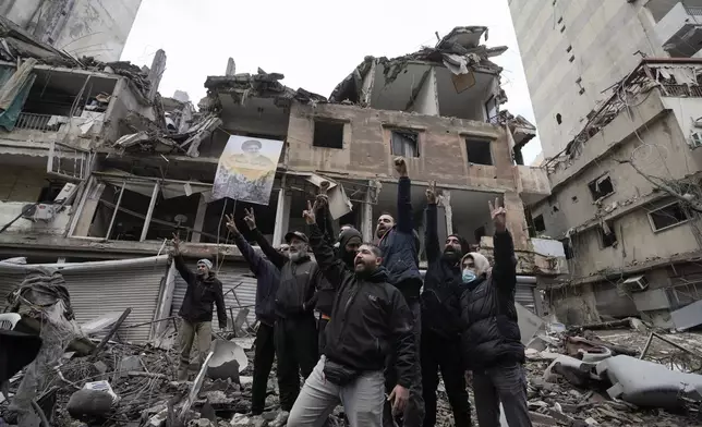 Hezbollah supporters cheer as they return to Dahiyeh, in Beirut, Lebanon, following a ceasefire between Israel and Hezbollah that went into effect on Wednesday, Nov. 27, 2024. (AP Photo/Bilal Hussein)