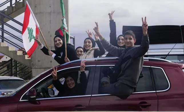 Displaced residents celebrate as they return to their villages following a ceasefire between Israel and Hezbollah that went into effect on Wednesday, Nov. 27, 2024, in Ablah, eastern Lebanon. (AP Photo/Hassan Ammar)