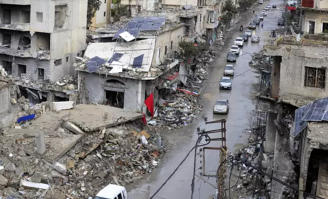 Displaced residents drive past destroyed buildings as they return to Nabatiyeh, Lebanon, after a ceasefire between Israel and Hezbollah went into effect on Wednesday, Nov. 27, 2024. (AP Photo/Mohammed Zaatari)