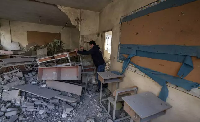 Teacher Ahmed Awada inspects his school that was damaged by an Israeli airstrike in Dahiyeh, Beirut, Lebanon, Friday, Nov. 29, 2024. (AP Photo/Bilal Hussein)