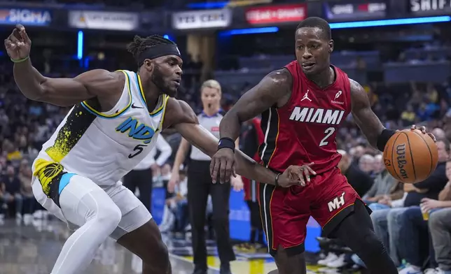 Miami Heat guard Terry Rozier (2) drives on Indiana Pacers forward Jarace Walker (5) during the first half of an NBA basketball game in Indianapolis, Sunday, Nov. 17, 2024. (AP Photo/Michael Conroy)