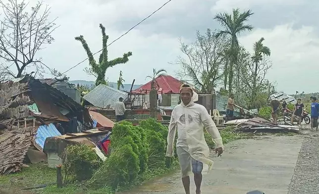 In this photo provided by the MDRRMO Viga Catanduanes, residents try to fix their damaged homes caused by Typhoon Man-yi in Viga, Catanduanes province, northeastern Philippines Sunday, Nov. 17, 2024. (MDRRMO Viga Catanduanes via AP)