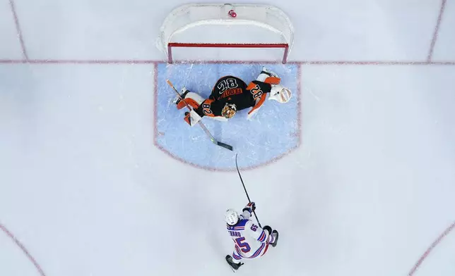 Philadelphia Flyers' Ivan Fedotov (82) blocks a shot by New York Rangers' Brett Berard (65) during the first period of an NHL hockey game, Friday, Nov. 29, 2024, in Philadelphia. (AP Photo/Matt Slocum)