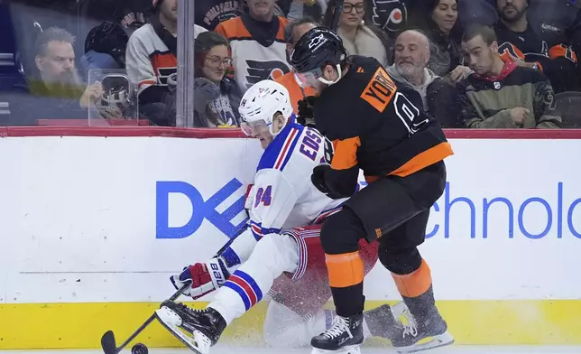 New York Rangers' Adam Edstrom, left, and Philadelphia Flyers' Cam York battle for the puck during the first period of an NHL hockey game, Friday, Nov. 29, 2024, in Philadelphia. (AP Photo/Matt Slocum)