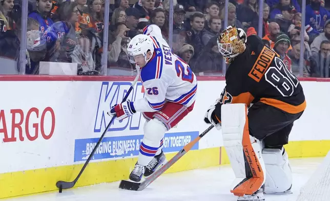 New York Rangers' Jimmy Vesey, left, and Philadelphia Flyers' Ivan Fedotov battle for the puck during the first period of an NHL hockey game, Friday, Nov. 29, 2024, in Philadelphia. (AP Photo/Matt Slocum)