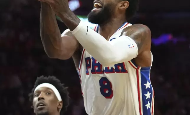 Philadelphia 76ers forward Paul George (8) goes to the basket past Miami Heat guard Josh Richardson (0) during the first half of an NBA basketball game, Monday, Nov. 18, 2024, in Miami. (AP Photo/Lynne Sladky)