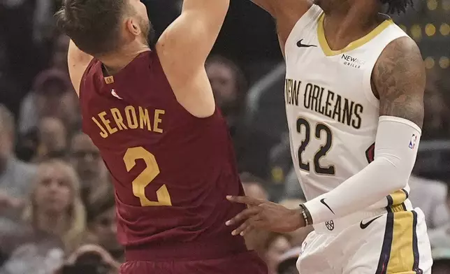 New Orleans Pelicans Elfrid Payton (22) blocks a shot by Cleveland Cavaliers guard Ty Jerome (2) in the first half of an NBA basketball game, Wednesday, Nov. 20, 2024, in Cleveland. (AP Photo/Sue Ogrocki)