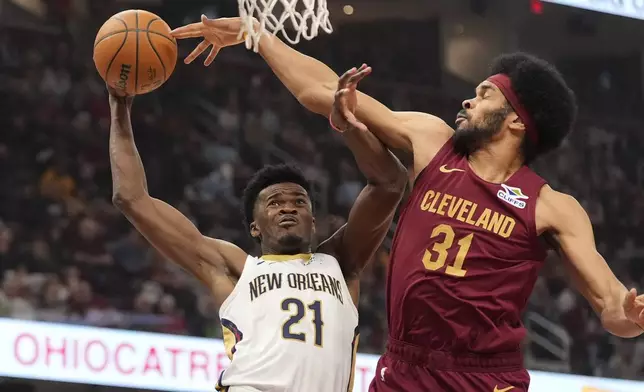 New Orleans Pelicans center Yves Missi (21) is fouled by Cleveland Cavaliers center Jarrett Allen (31) in the first half of an NBA basketball game, Wednesday, Nov. 20, 2024, in Cleveland. (AP Photo/Sue Ogrocki)