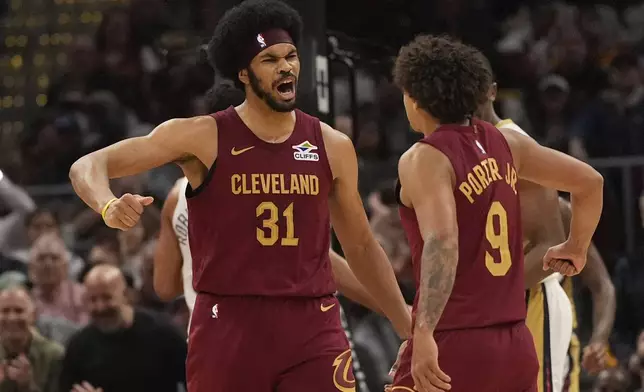 Cleveland Cavaliers center Jarrett Allen (31) celebrates a dunk with teammate Craig Porter Jr. (9) in the first half of an NBA basketball game against the New Orleans Pelicans, Wednesday, Nov. 20, 2024, in Cleveland. (AP Photo/Sue Ogrocki)