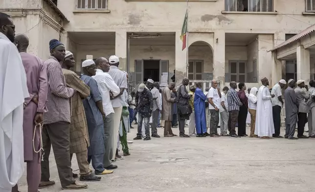 People line up to cast their ballot for legislative elections in Dakar, Senegal, Sunday, Nov. 17, 2024. (AP Photo/Annika Hammerschlag)