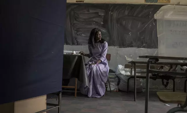 An electoral employee begins the assembly of a voting station for legislative elections in Dakar, Senegal Sunday, Nov. 17, 2024. (AP Photo/Annika Hammerschlag)