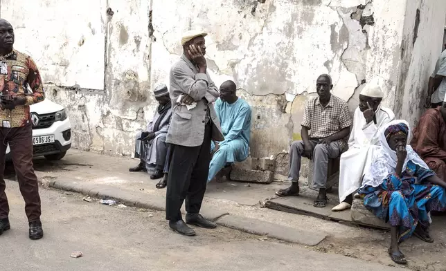 People wait to cast their ballot for legislative elections in Dakar, Senegal Sunday, Nov. 17, 2024. (AP Photo/Annika Hammerschlag)