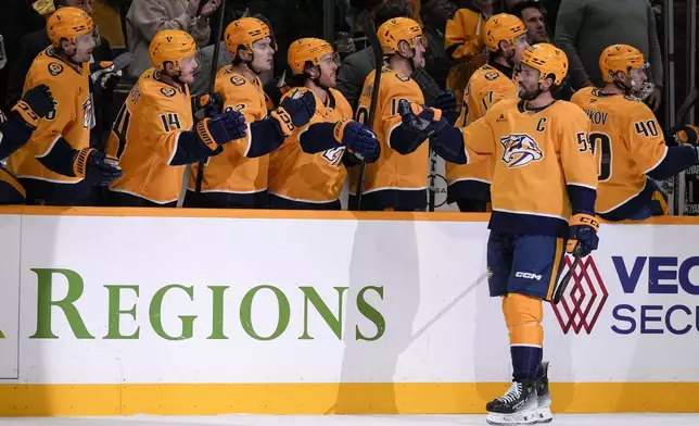 Nashville Predators defenseman Roman Josi (59) celebrates his goal with teammates during the first period of an NHL hockey game against the Philadelphia Flyers, Wednesday, Nov. 27, 2024, in Nashville, Tenn. (AP Photo/George Walker IV)