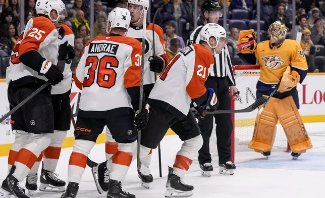 Philadelphia Flyers center Scott Laughton (21) celebrates his goal with teammates during the first period of an NHL hockey game against the Nashville Predators, Wednesday, Nov. 27, 2024, in Nashville, Tenn. (AP Photo/George Walker IV)