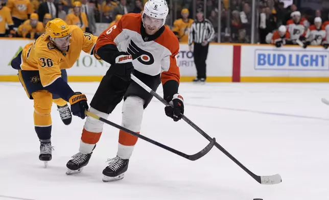 Philadelphia Flyers defenseman Travis Sanheim (6) skates the puck past Nashville Predators left wing Cole Smith (36) during the third period of an NHL hockey game Wednesday, Nov. 27, 2024, in Nashville, Tenn. The Flyers won 3-2 in overtime(AP Photo/George Walker IV)