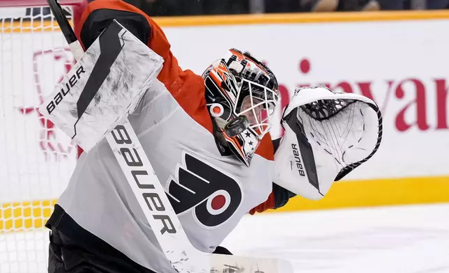 Philadelphia Flyers goaltender Aleksei Kolosov (35) blocks a shot on goal in overtime of an NHL hockey game against the Nashville Predators, Wednesday, Nov. 27, 2024, in Nashville, Tenn. The Flyers won 3-2. (AP Photo/George Walker IV)