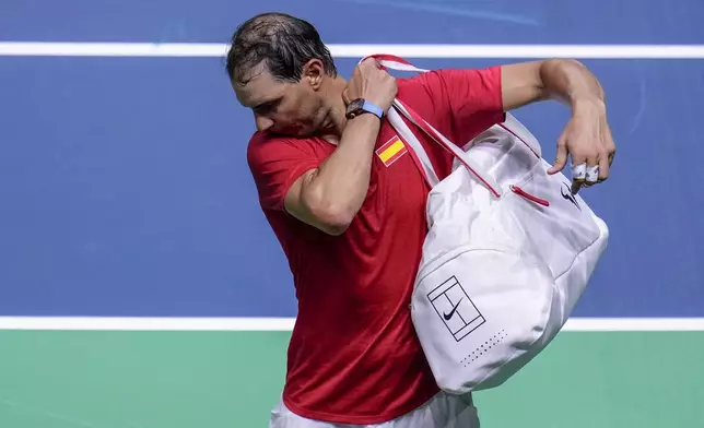 Spain's tennis player Rafael Nadal leaves the court after losing against Netherlands' Botic Van De Zandschulp during a Davis Cup quarterfinal match at Martin Carpena Sports Hall in Malaga, southern Spain, on Tuesday, Nov. 19, 2024. (AP Photo/Manu Fernandez)