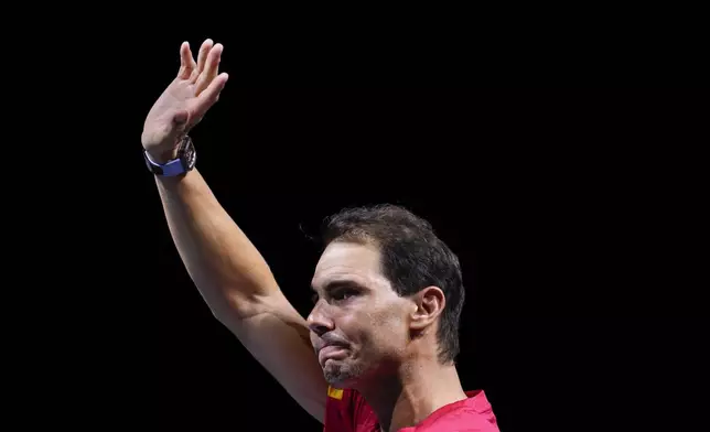 Spain's Rafael Nadal waves to the crowd during a tribute after playing his last match as a professional tennis player in the Davis Cup quarterfinals at the Martin Carpena Sports Hall in Malaga, southern Spain, on early Wednesday, Nov. 20, 2024. (AP Photo/Manu Fernandez)