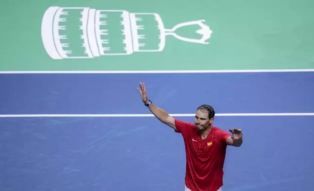 Spain's tennis player Rafael Nadal waves to the crowd after losing against Netherlands' Botic Van De Zandschulp during a Davis Cup quarterfinal match at Martin Carpena Sports Hall in Malaga, southern Spain, on Tuesday, Nov. 19, 2024. (AP Photo/Manu Fernandez)