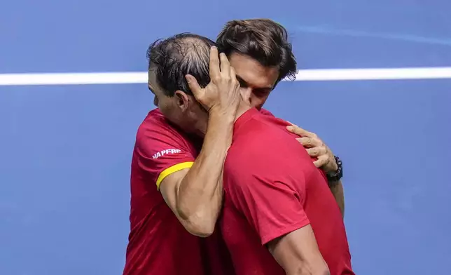 Spain's tennis player Rafael Nadal embraces David Ferrer, captain of Team Spain, after losing against Netherlands' Botic Van De Zandschulp during a Davis Cup quarterfinal match at Martin Carpena Sports Hall in Malaga, southern Spain, on Tuesday, Nov. 19, 2024. (AP Photo/Manu Fernandez)