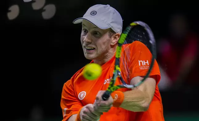 Netherlands' Botic Van De Zandschulp returns the ball against Spain's tennis player Rafael Nadal during a Davis Cup quarterfinal match at Martin Carpena Sports Hall in Malaga, southern Spain, on Tuesday, Nov. 19, 2024. (AP Photo/Manu Fernandez)