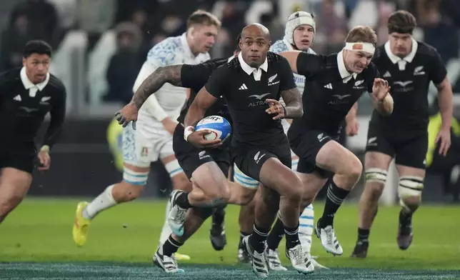 New Zealand's Mark Tele'a makes a break during the Autumn Nations Series rugby union match between Italy and the All Blacks at the Allianz stadium, in Turin, Italy, Saturday, Nov. 23, 2024. (AP Photo/Luca Bruno)