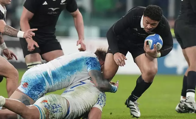 New Zealand's Caleb Clarke runs at the defence during the Autumn Nations Series rugby union match between Italy and the All Blacks at the Allianz stadium, in Turin, Italy, Saturday, Nov. 23, 2024. (AP Photo/Luca Bruno)