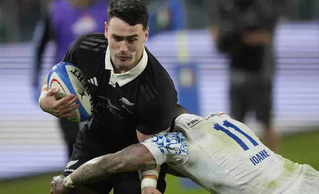 New Zealand's Will Jordan is tackled by Italy's Monty Ioane during the Autumn Nations Series rugby union match between Italy and the All Blacks at the Allianz stadium, in Turin, Italy, Saturday, Nov. 23, 2024. (AP Photo/Luca Bruno)