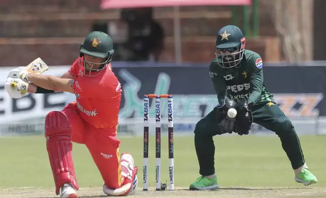 Zimbabwe's Craig Ervine, left, at the wicket as Pakistan's wicket keeper Mohammad Rizwan catches the ball, during the second ODI cricket match between Zimbabwe and Pakistan, at Queens Sports Club, in Bulawayo, Zimbabwe, Tuesday, Nov. 26, 2024. (AP Photo/Wonder Mashura)