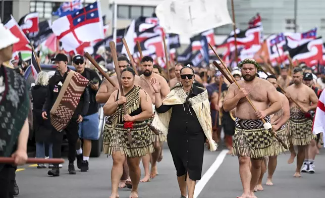 Indigenous Māori people walk through the streets of Wellington, New Zealand to protest against a proposed law that would redefine the country's founding agreement between Indigenous Māori and the British Crown, Tuesday, Nov. 19, 2024. (AP Photo/Mark Tantrum)