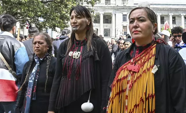 Members of Te Āti Awa, join thousands of people gathered outside New Zealand's parliament to protest a proposed law that would redefine the country's founding agreement between Indigenous Māori and the British Crown, in Wellington Tuesday, Nov. 19, 2024. (AP Photo/Mark Tantrum)