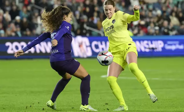 Orlando Pride midfielder Angelina, left, battles Washington Spirit midfielder Hal Hershfelt, right, for a ball during the first half of the NWSL championship at CPKC Stadium, Saturday, Nov. 23, 2024, in Kansas City, Mo. (AP Photo/Reed Hoffmann)