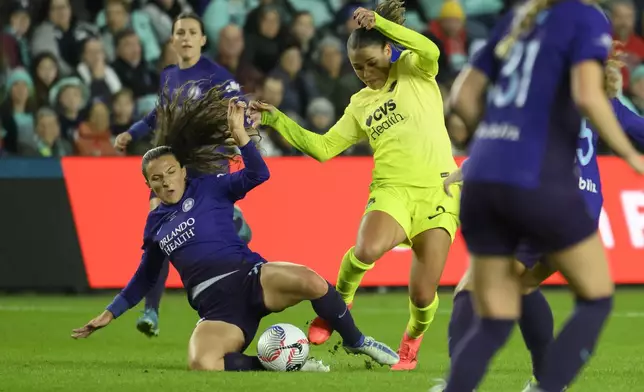 Orlando Pride defender Kerry Abello, left, and Washington Spirit forward Trinity Rodman, right, battle for the ball during the first half of the NWSL championship at CPKC Stadium, Saturday, November 23, 2024, in Kansas City, Mo. (AP Photo/Reed Hoffmann)