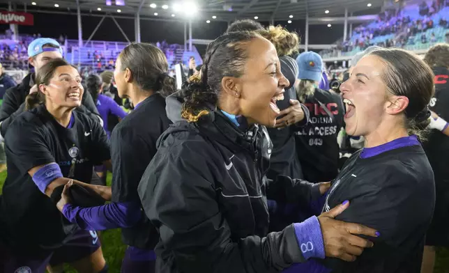 Orlando Pride team members celebrate after they defeated the Washington Spirit in the NWSL championship soccer game at CPKC Stadium, Saturday, Nov. 23, 2024, in Kansas City, Mo. (AP Photo/Reed Hoffmann)