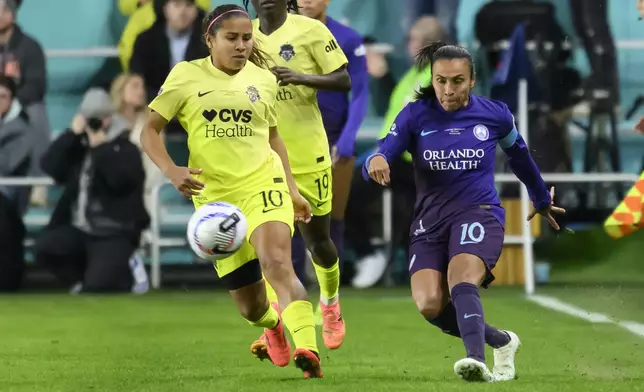 Orlando Pride forward Marta (10) and Washington Spirit midfielder Leicy Santos (10) battle for the ball during the first half of the NWSL championship at CPKC Stadium, Saturday, November 23, 2024, in Kansas City, Mo. (AP Photo/Reed Hoffmann)