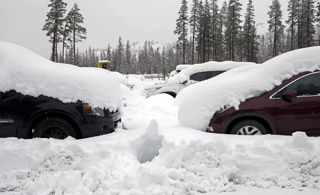 Cars are covered in snow during a storm Thursday, Nov. 21, 2024, in Soda Springs, Calif. (AP Photo/Brooke Hess-Homeier)