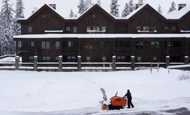 A worker clears a road with a snow blower during a storm Thursday, Nov. 21, 2024, at Sugar Bowl Ski Resort in Norden, Calif. (AP Photo/Brooke Hess-Homeier)