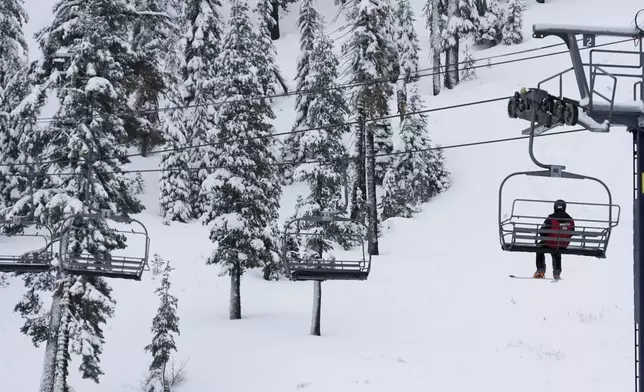 A lone skier rides on a lift Thursday, Nov. 21, 2024, at Sugar Bowl Ski Resort in Norden, Calif. (AP Photo/Brooke Hess-Homeier)