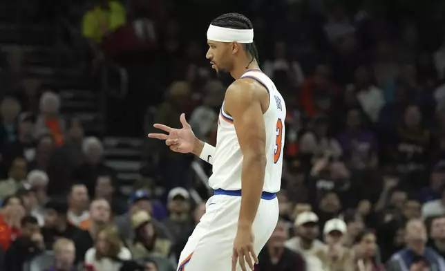 New York Knicks guard Josh Hart celebrates a made 3-pointer by Knicks' Mikal Bridges against the Phoenix Suns during the first half of an NBA basketball game Wednesday, Nov. 20, 2024, in Phoenix. (AP Photo/Ross D. Franklin)