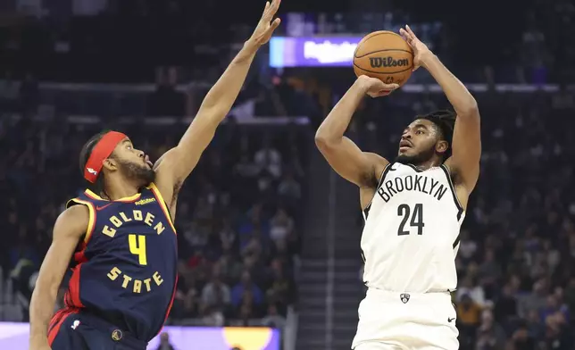 Brooklyn Nets guard Cam Thomas (24) looks to shoot against Golden State Warriors guard Moses Moody (4) during the first half of an NBA basketball game in San Francisco, Monday, Nov. 25, 2024. (AP Photo/Jed Jacobsohn)