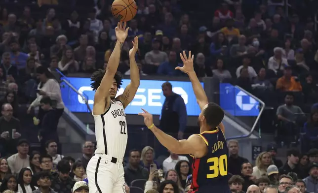 Brooklyn Nets forward Jalen Wilson (22) shoots against Golden State Warriors guard Stephen Curry (30) during the first half of an NBA basketball game in San Francisco, Monday, Nov. 25, 2024. (AP Photo/Jed Jacobsohn)