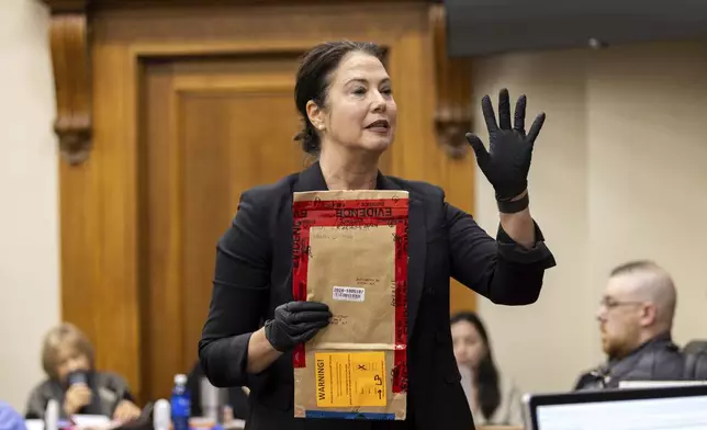 CORRECTS DATE Prosecutor Sheila Ross speaks while holding an evidence bag during the trial for Jose Ibarra at the Athens-Clarke County Superior Court on Tuesday, Nov. 19, 2024, in Athens, Ga. (Arvin Temkar/Atlanta Journal-Constitution via AP, Pool)