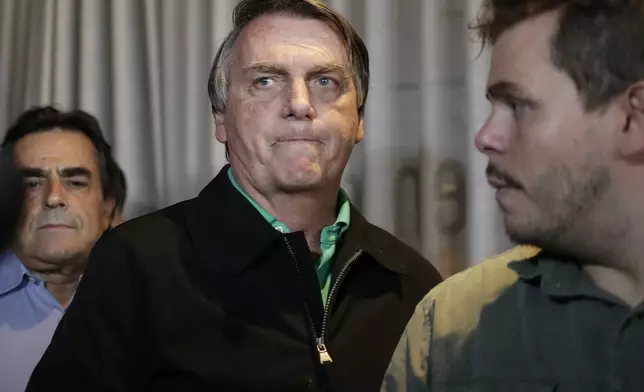 FILE - Brazil's former President Jair Bolsonaro prepares to speak to the press in Belo Horizonte, Brazil, June 30, 2023, the day that judges ruled him ineligible to run for political office until 2030 after concluding that he abused his power and cast unfounded doubts on the country's electronic voting system. (AP Photo/Thomas Santos, File)