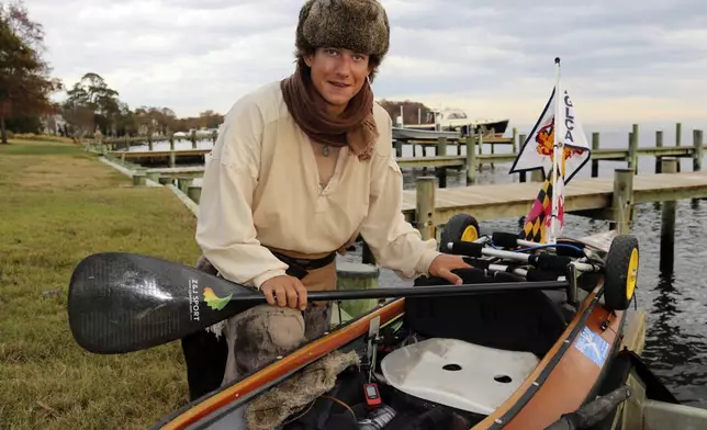 Peter Frank, who is attempting to make a roughly 6,000-mile trip in his canoe to complete the Great Loop, poses by his canoe Thursday, Nov. 7, 2024, in Annapolis, Md. (AP Photo/Brian Witte)