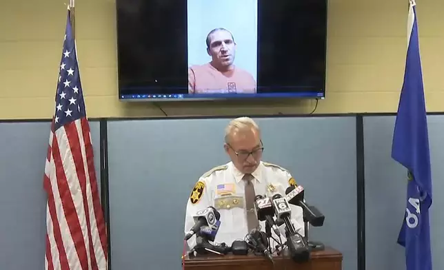 This still image provided by Green Lake County Sheriff's Office, Sheriff Mark Podoll holds a news conference regarding Ryan Borgwardt, who faked his own drowning this summer on Thursday, Nov. 21, 2024 in Green Lake, Wis. (Green Lake County Sheriff's Office via AP)