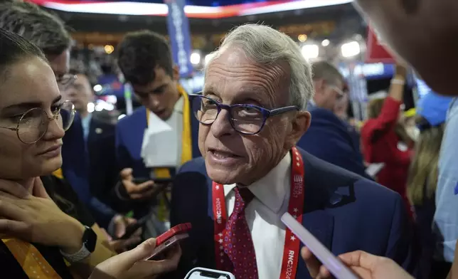 FILE - Ohio Gov. Mike DeWine talks to reporters during the Republican National Convention July 15, 2024, in Milwaukee. (AP Photo/Paul Sancya, File)