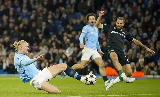 Manchester City's Erling Haaland scores his side's third goal during the Champions League opening phase soccer match between Manchester City and Feyenoord at the Etihad Stadium in Manchester, England, Tuesday, Nov. 26, 2024. (AP Photo/Dave Thompson)